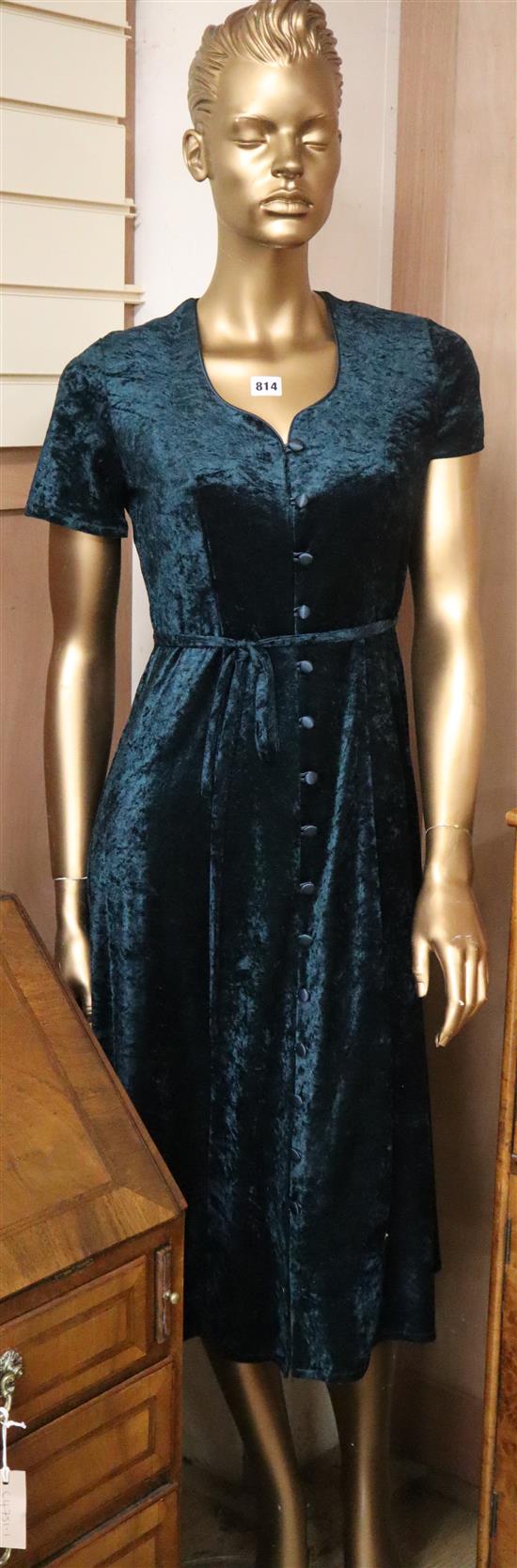 A shop display mannequin with green velvet crush dress H.188cm